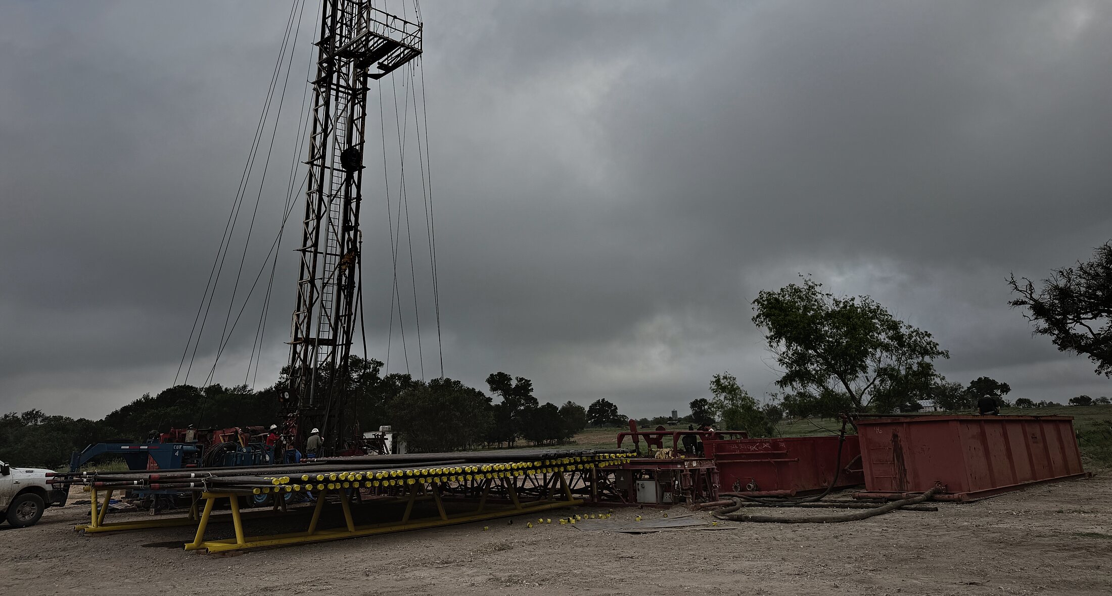 Workover rig standing over Vaughan Well No. 1 with tubing racked in the foreground, Gonzales County, Texas
